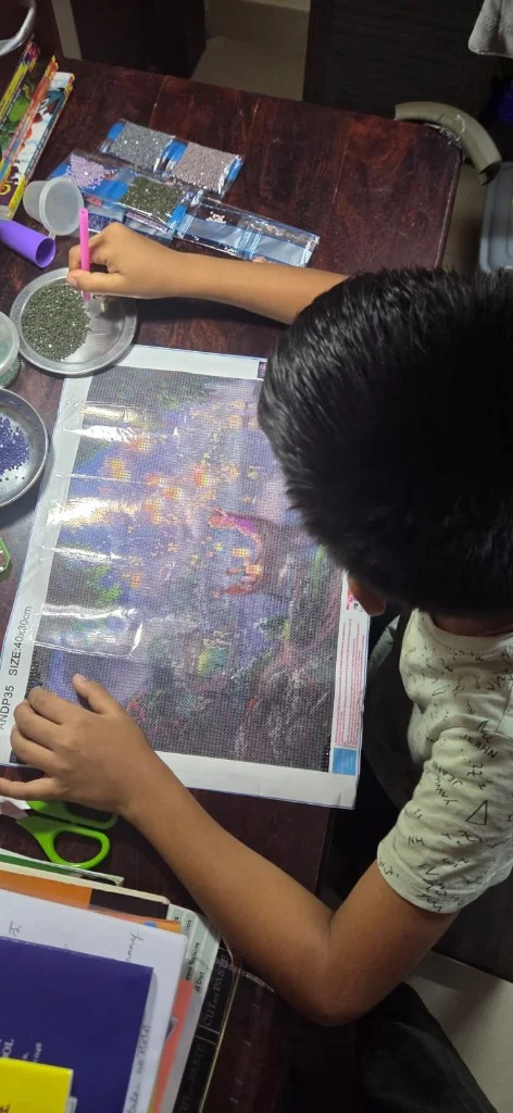 Aayaan doing diamond mosaic gem painting