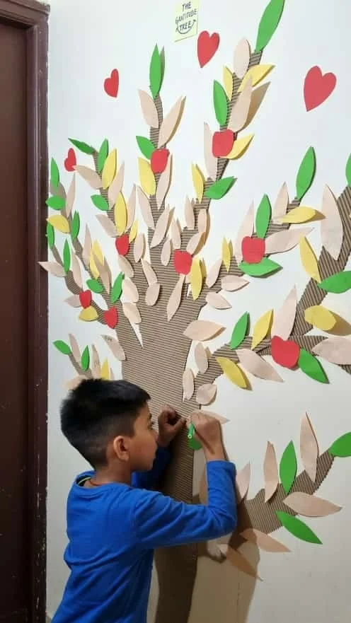 Aayaan making The Gratitude Tree wall art