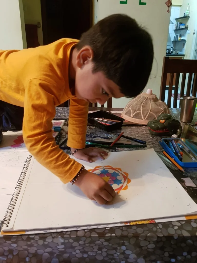 Aayaan drawing geometric mandala rangoli