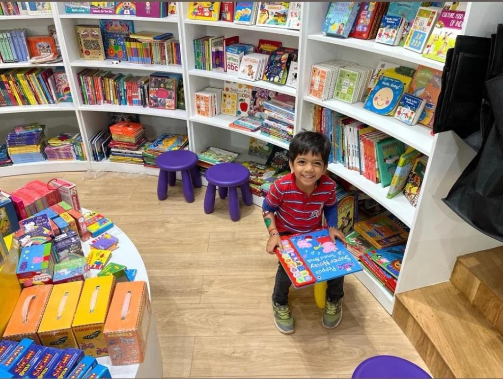 Aayaan in the bookstore reading books