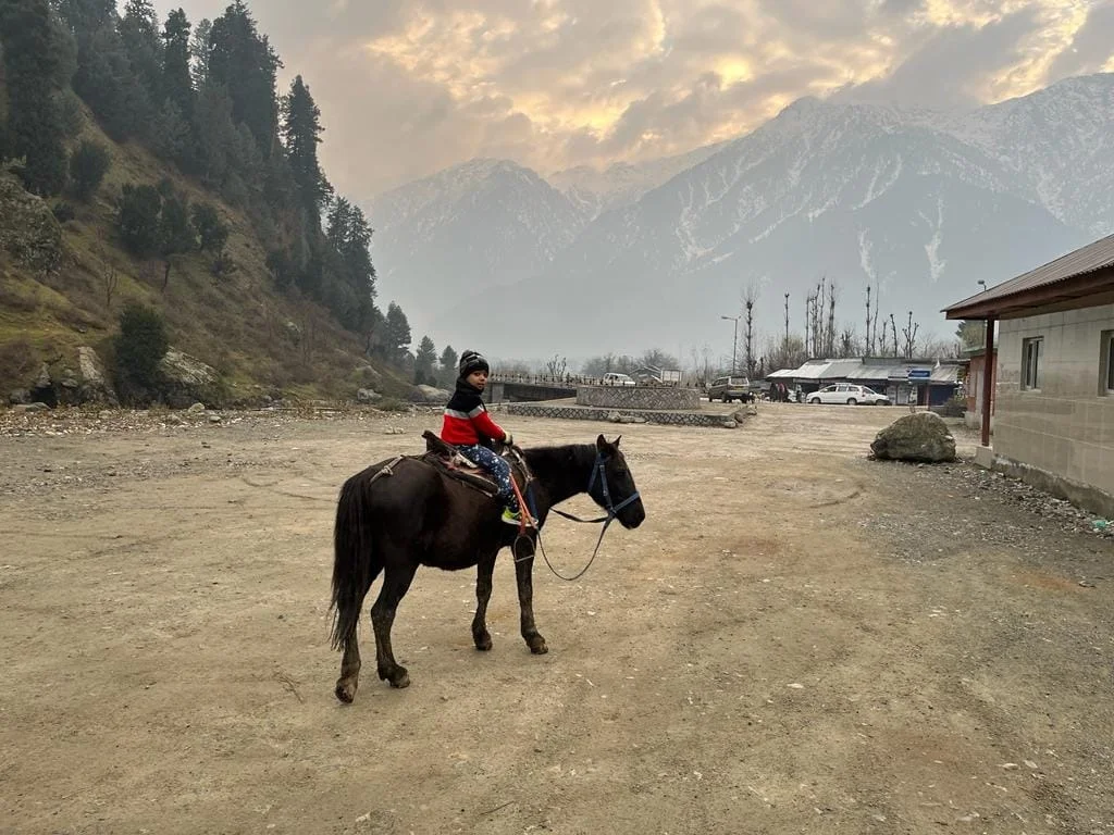 Aayaan in pink winter jacket in snow