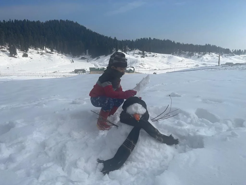 Aayaan building a snowman in Kashmir