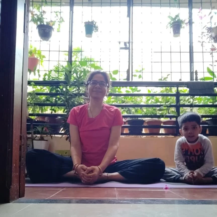 Aayaan doing butterfly pose yoga with his mother